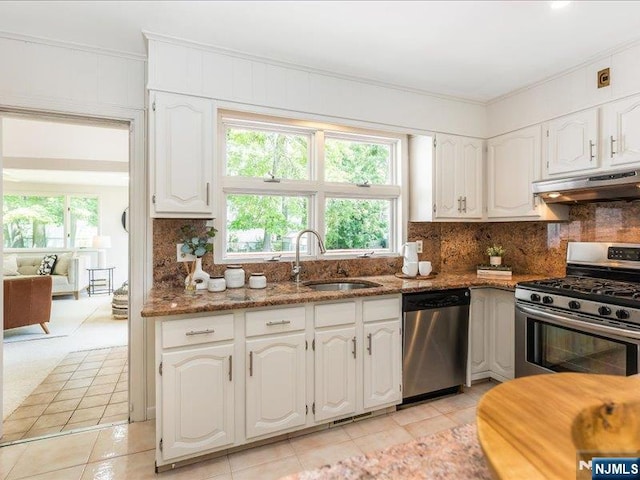100 Darling Ave, Bloomfield, NJ 07003 - kitchen with stainless steel appliances, under cabinet range hood, healthy amount of natural light, white cabinets, and ornamental molding