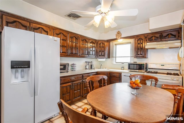 6 Rutgers Pl, Clifton, NJ 07013 - kitchen with white appliances, under cabinet range hood, ceiling fan, light countertops, and light tile patterned flooring