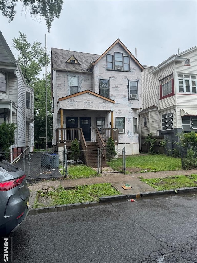 102 17th St, East Orange, NJ 07017 - view of front facade featuring a fenced front yard, a gate, and covered porch