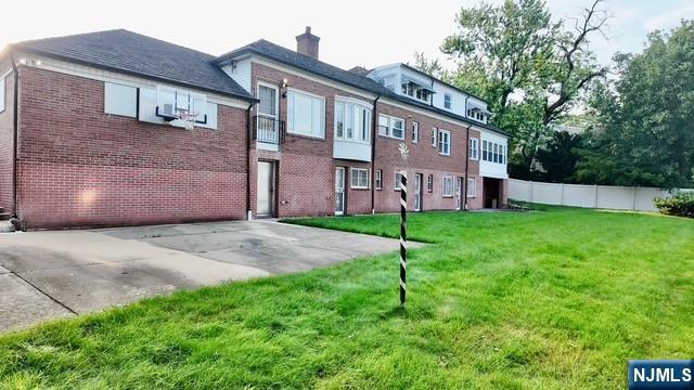 313-321 39th St, Paterson, NJ 07504 - back of property featuring brick siding and a chimney