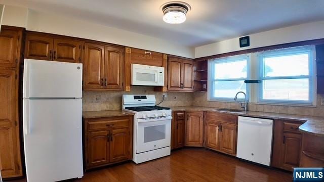 313-321 39th St, Paterson, NJ 07504 - kitchen with white appliances, decorative backsplash, dark wood-style flooring, and brown cabinets