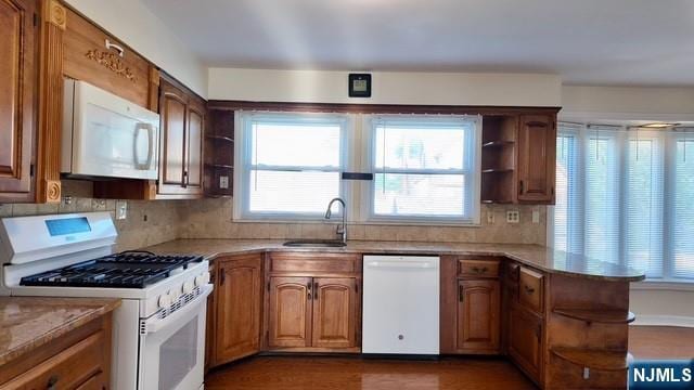 313-321 39th St, Paterson, NJ 07504 - kitchen featuring white appliances, open shelves, a peninsula, tasteful backsplash, and dark wood-style floors