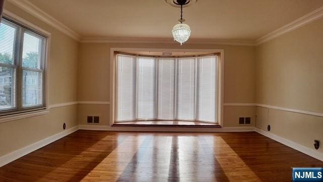313-321 39th St, Paterson, NJ 07504 - unfurnished dining area featuring wood finished floors and crown molding