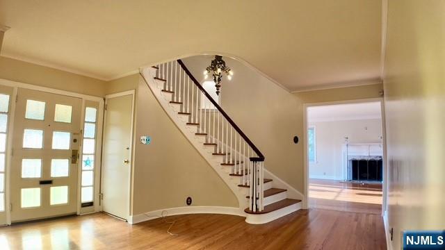 313-321 39th St, Paterson, NJ 07504 - foyer with wood finished floors, stairs, crown molding, and plenty of natural light