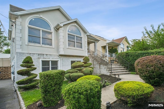 286 State Rt 17, Rutherford, NJ 07070 - view of front facade with stucco siding, brick siding, and stairs