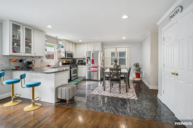 286 State Rt 17, Rutherford, NJ 07070 - kitchen with appliances with stainless steel finishes, backsplash, crown molding, glass insert cabinets, and a peninsula