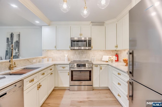 1 Claridge Dr Unit 418, Verona, NJ 07044 - kitchen with stainless steel appliances, white cabinets, light wood finished floors, tasteful backsplash, and crown molding