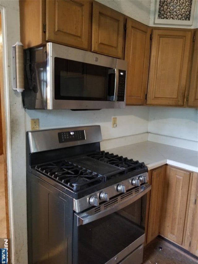 734 Broad St, Bloomfield, NJ 07003 - kitchen featuring stainless steel appliances, light countertops, and brown cabinets