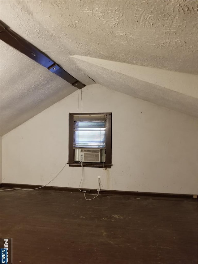 734 Broad St, Bloomfield, NJ 07003 - additional living space featuring wood finished floors, vaulted ceiling, a textured ceiling, and cooling unit