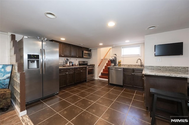 71 Pickens St, Little Ferry, NJ 07643 - kitchen featuring stainless steel appliances, dark brown cabinets, dark tile patterned flooring, recessed lighting, and light stone countertops