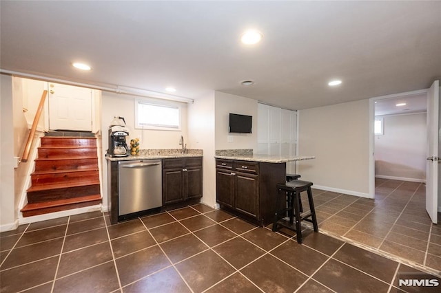 71 Pickens St, Little Ferry, NJ 07643 - kitchen with dishwasher, dark brown cabinetry, a breakfast bar area, dark tile patterned flooring, and recessed lighting