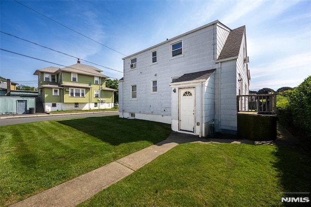 71 Pickens St, Little Ferry, NJ 07643 - rear view of house featuring a shingled roof and a lawn