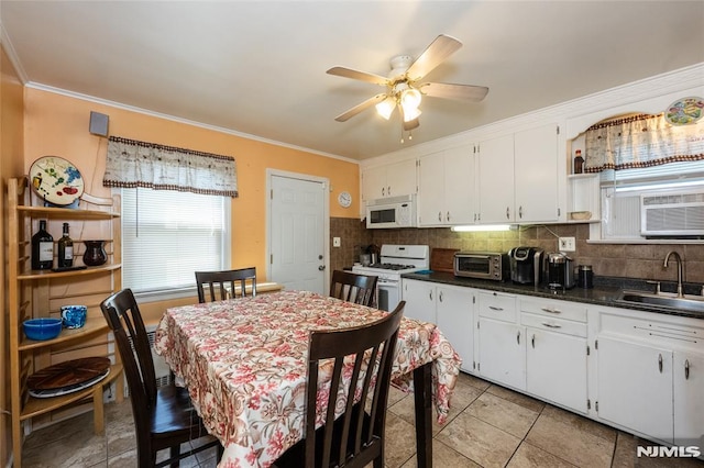 71 Pickens St, Little Ferry, NJ 07643 - kitchen with white appliances, crown molding, dark countertops, white cabinetry, and backsplash