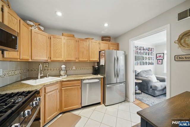 92 Maple Ln Unit 3021, Mount Arlington Boro, NJ 07856 - kitchen featuring appliances with stainless steel finishes, light brown cabinets, backsplash, light tile patterned floors, and light countertops