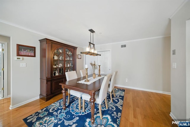 92 Maple Ln Unit 3021, Mount Arlington Boro, NJ 07856 - dining room featuring light wood-type flooring, ornamental molding, and a chandelier