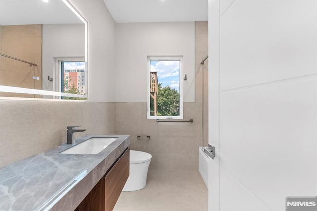 135 Old Palisade Rd, Fort Lee, NJ 07024 - full bathroom featuring tile walls, vanity, and a wainscoted wall