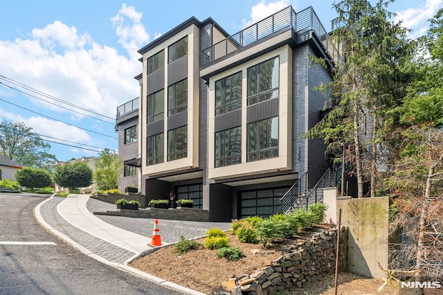 135 Old Palisade Rd, Fort Lee, NJ 07024 - view of property exterior featuring a garage