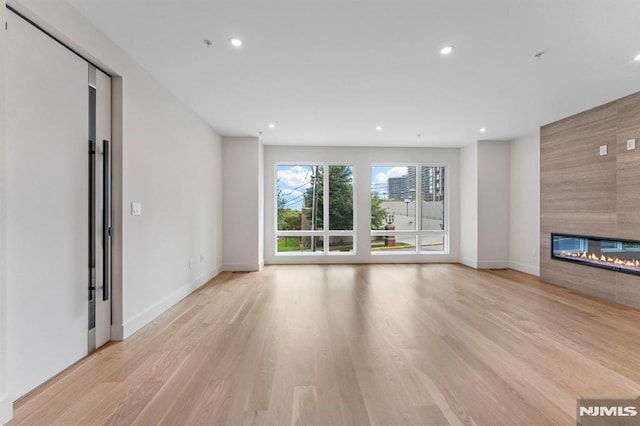 135 Old Palisade Rd, Fort Lee, NJ 07024 - unfurnished living room with recessed lighting, light wood-style flooring, and a fireplace