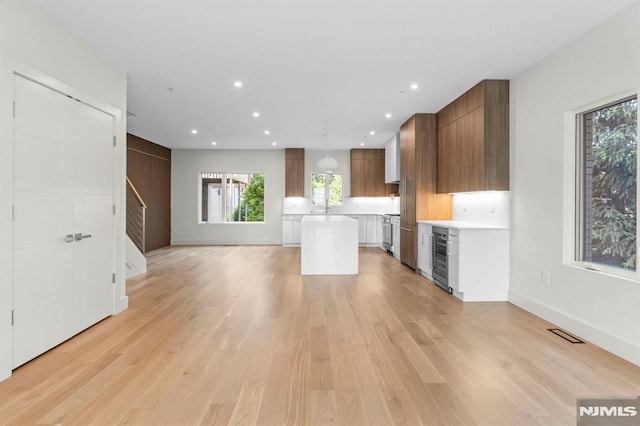 135 Old Palisade Rd, Fort Lee, NJ 07024 - kitchen featuring light countertops, beverage cooler, a center island, healthy amount of natural light, and recessed lighting