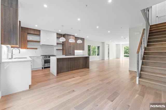 135 Old Palisade Rd, Fort Lee, NJ 07024 - kitchen with stainless steel stove, modern cabinets, a center island, light countertops, and recessed lighting