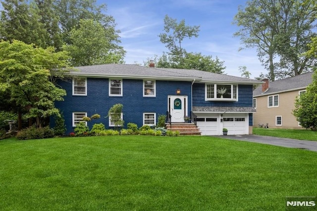 117 Morton Dr, Ramsey, NJ 07446 - split foyer home with driveway, a garage, a front yard, and a chimney