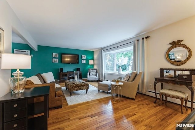 117 Morton Dr, Ramsey, NJ 07446 - living room featuring wood finished floors, a baseboard radiator, and an AC wall unit