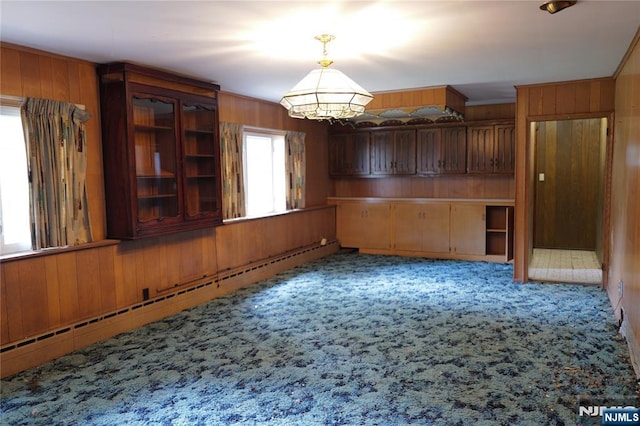 106 Prescott St, Demarest, NJ 07627 - unfurnished dining area with wood walls, light carpet, a baseboard heating unit, and a chandelier