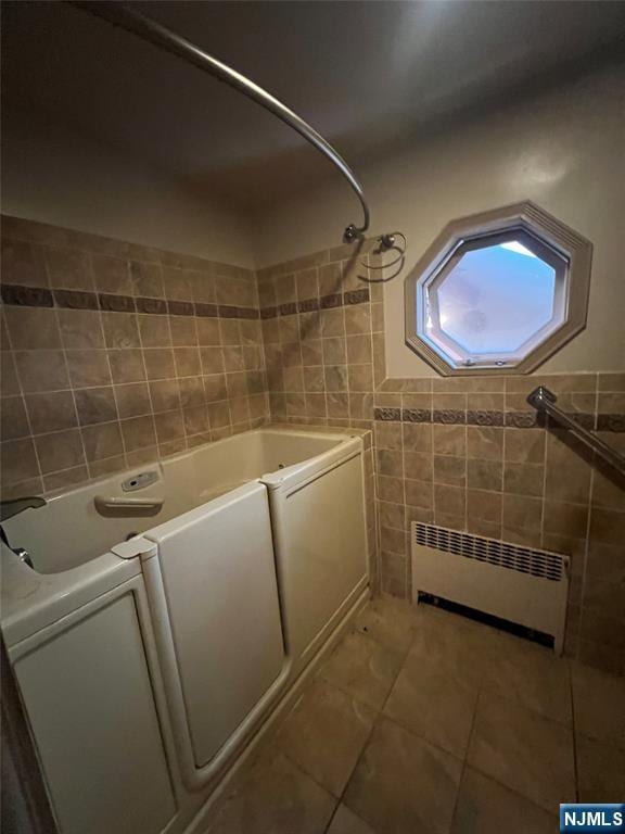 106 Prescott St, Demarest, NJ 07627 - bathroom featuring radiator, tile walls, and tile patterned flooring