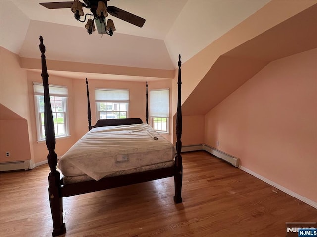 106 Prescott St, Demarest, NJ 07627 - bedroom featuring lofted ceiling, a baseboard radiator, multiple windows, and wood finished floors