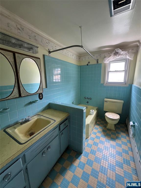106 Prescott St, Demarest, NJ 07627 - bathroom featuring tile walls, shower / washtub combination, vanity, tile patterned floors, and ornamental molding