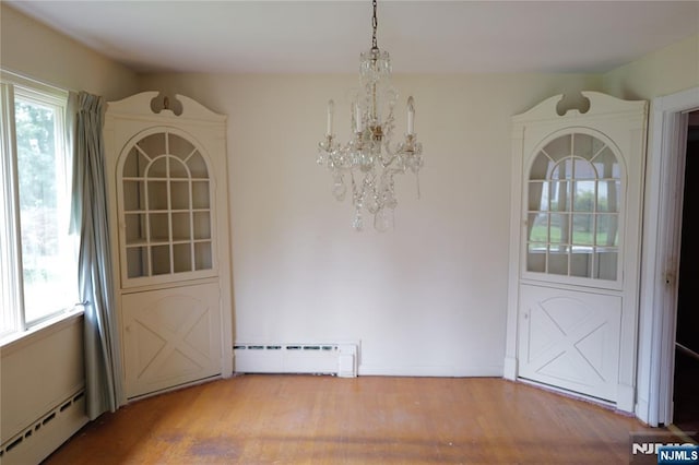 106 Prescott St, Demarest, NJ 07627 - unfurnished dining area featuring a baseboard heating unit, a chandelier, and plenty of natural light