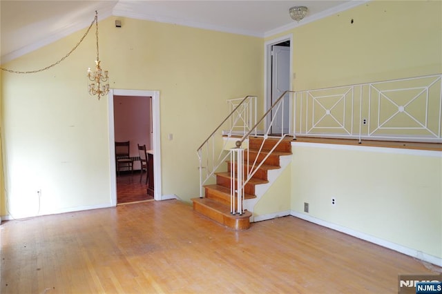 106 Prescott St, Demarest, NJ 07627 - stairs with a chandelier, wood finished floors, crown molding, and vaulted ceiling