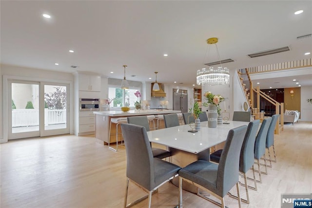 415 Bailey Rd, Paramus, NJ 07652 - dining area featuring light wood-type flooring, recessed lighting, stairs, and a chandelier