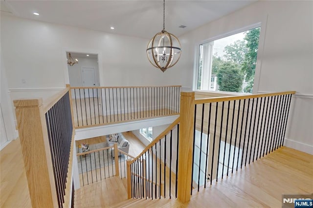 415 Bailey Rd, Paramus, NJ 07652 - stairs featuring a chandelier, healthy amount of natural light, wood finished floors, and recessed lighting