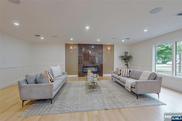 415 Bailey Rd, Paramus, NJ 07652 - living room with wood finished floors, a fireplace, recessed lighting, wainscoting, and a decorative wall
