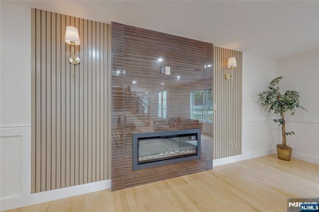 415 Bailey Rd, Paramus, NJ 07652 - detailed view of a glass covered fireplace, wood finished floors, and a decorative wall