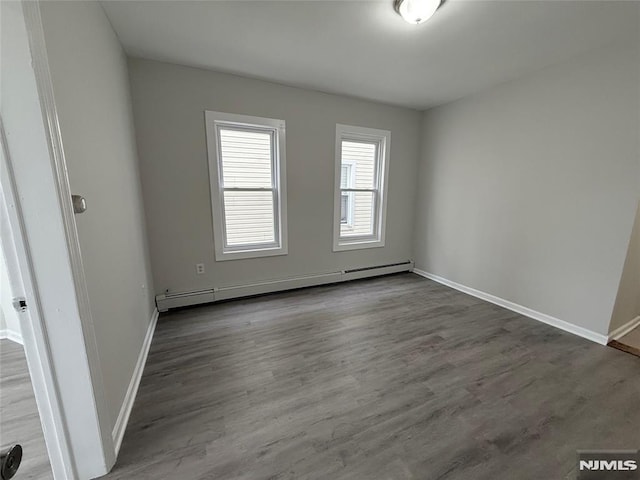 1 9th Ave, East Orange, NJ 07018 - unfurnished room with a baseboard radiator and wood finished floors