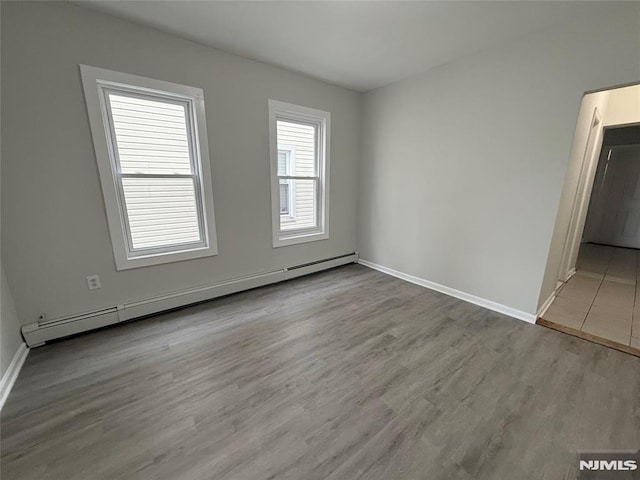 1 9th Ave, East Orange, NJ 07018 - spare room with a baseboard radiator and wood finished floors