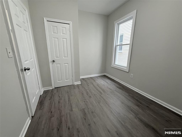 1 9th Ave, East Orange, NJ 07018 - unfurnished bedroom featuring dark wood-style floors and baseboards