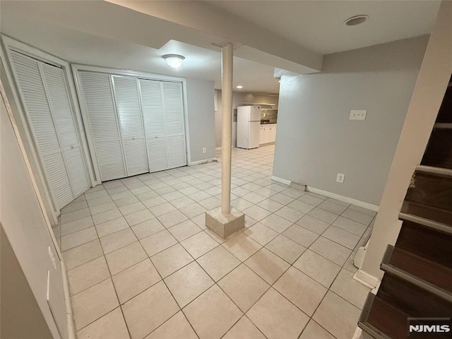 1 9th Ave, East Orange, NJ 07018 - finished below grade area featuring freestanding refrigerator, light tile patterned floors, and stairway