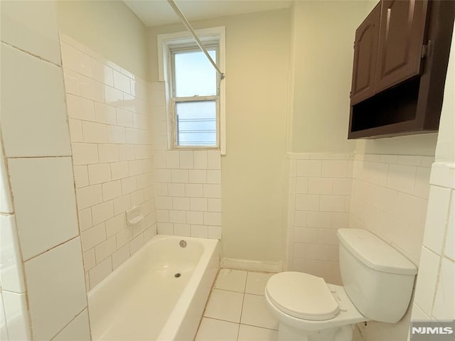 1 9th Ave, East Orange, NJ 07018 - bathroom with tile patterned floors,  shower combination, and tile walls