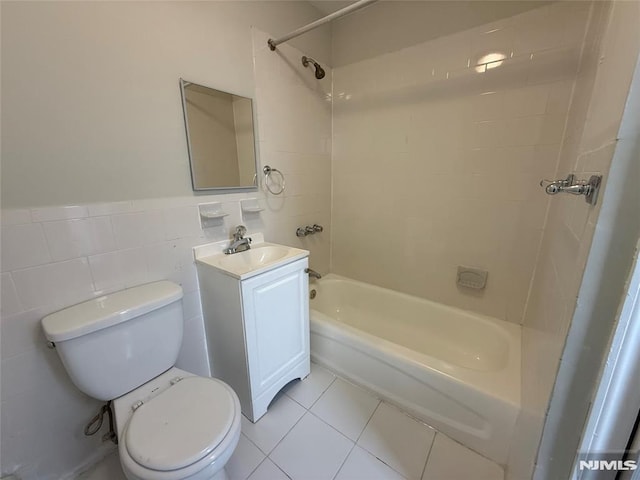 1 9th Ave, East Orange, NJ 07018 - bathroom featuring washtub / shower combination, vanity, tile patterned flooring, a wainscoted wall, and tile walls