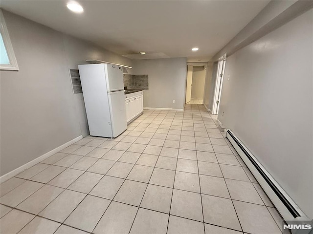 1 9th Ave, East Orange, NJ 07018 - kitchen featuring freestanding refrigerator, baseboard heating, recessed lighting, light tile patterned flooring, and white cabinetry