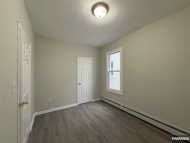 1 9th Ave, East Orange, NJ 07018 - unfurnished bedroom with a baseboard radiator and wood finished floors