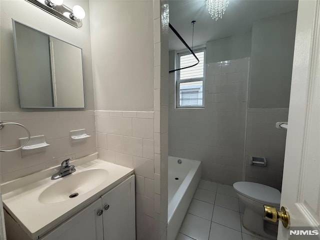 1 9th Ave, East Orange, NJ 07018 - full bathroom featuring tile walls, tile patterned floors, vanity, wainscoting, and  shower combination