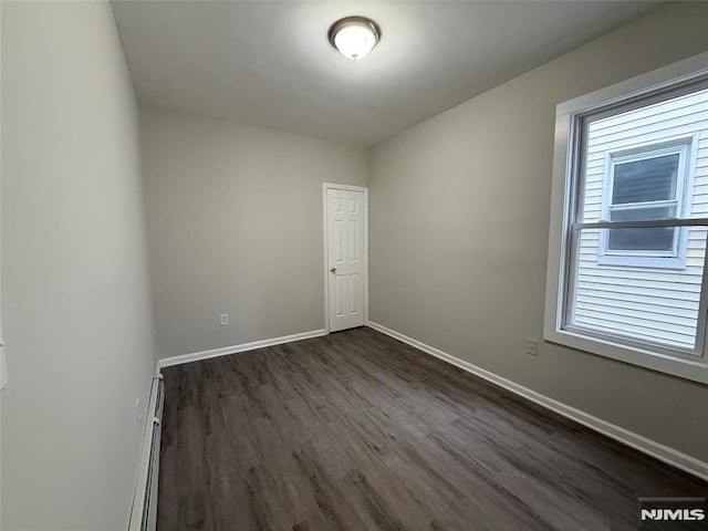 1 9th Ave, East Orange, NJ 07018 - empty room with dark wood-type flooring and a baseboard radiator