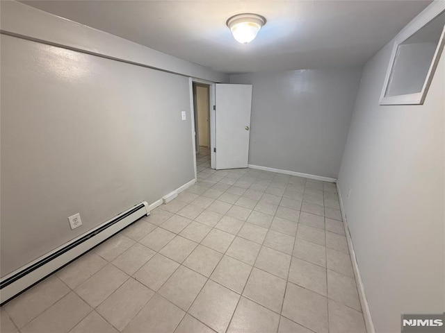 1 9th Ave, East Orange, NJ 07018 - empty room with a baseboard radiator and light tile patterned flooring