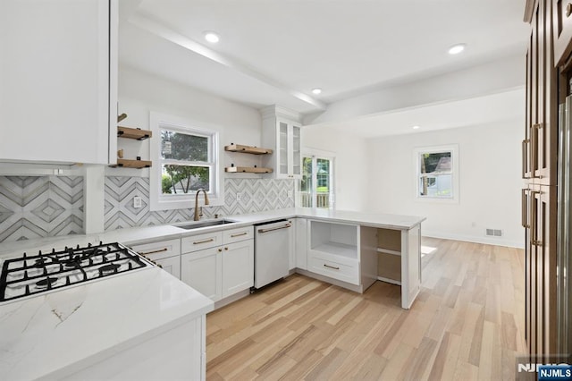 26 Lake, North Haledon, NJ 07508 - kitchen with white dishwasher, open shelves, a peninsula, tasteful backsplash, and light wood-style flooring