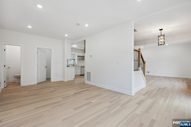 26 Lake, North Haledon, NJ 07508 - unfurnished living room featuring light wood-type flooring, stairway, recessed lighting, and a chandelier