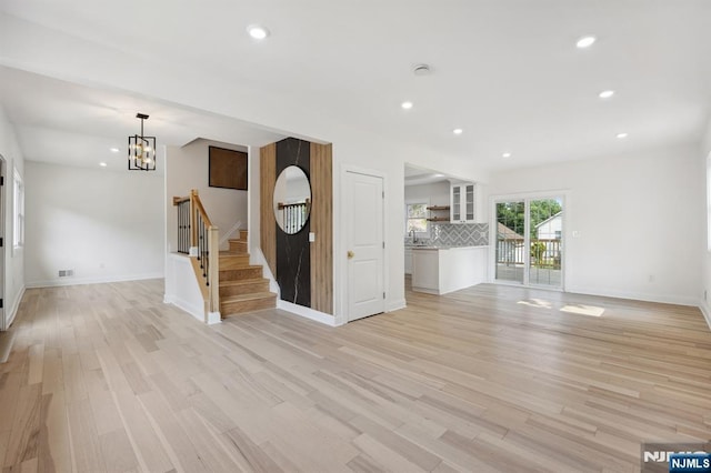 26 Lake, North Haledon, NJ 07508 - unfurnished living room with a chandelier, stairway, light wood-type flooring, and recessed lighting